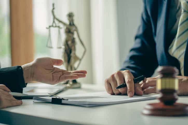 Immigration lawyer consulting client after arrest in NYC office
