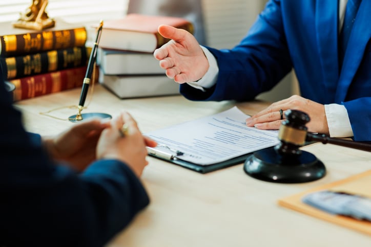 Criminal defense attorney advising immigrant client about plea agreement