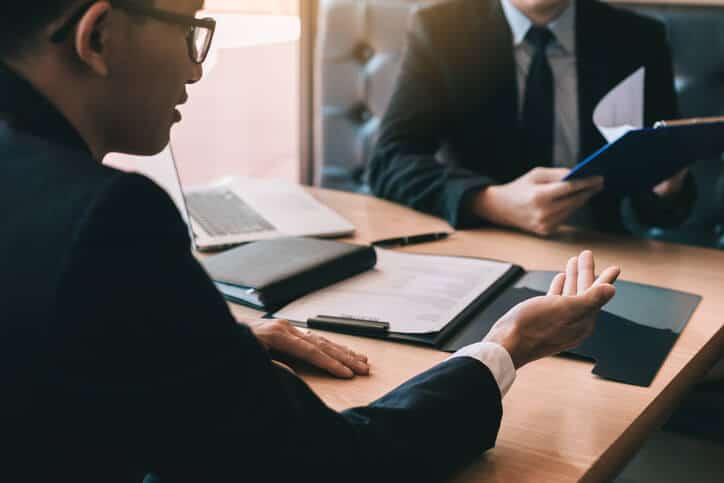 Attorney consulting with a non-citizen client about criminal charges and immigration consequences in New York