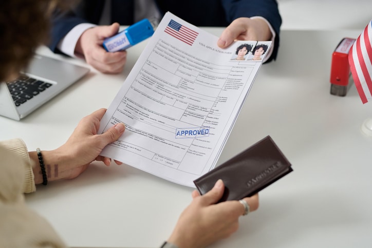  Applicant reviewing naturalization paperwork with legal guidance.