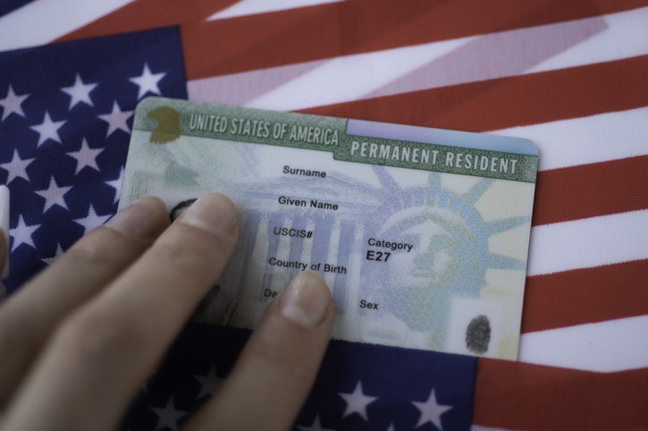 Permanent resident card next to legal documents
