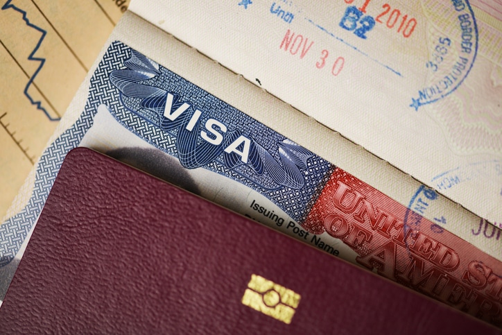 Green card and passport on a desk
