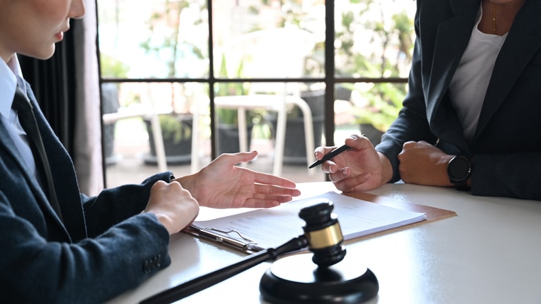Immigration attorney reviewing criminal court documents with client