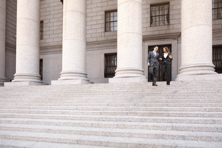 Criminal defense lawyer and client outside court after plea negotiations