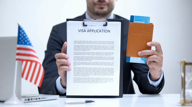 Immigration official reviewing an application and passport during a legal immigration appointment