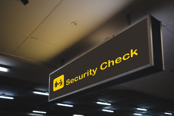 Travelers waiting in line at an airport security checkpoint