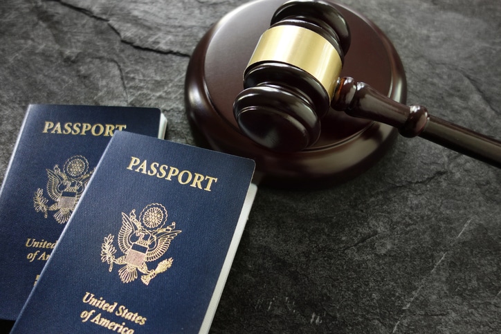 Judge’s gavel beside U.S. passports representing criminal and immigration law