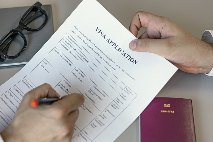 Immigration professional reviewing visa application and passport documents