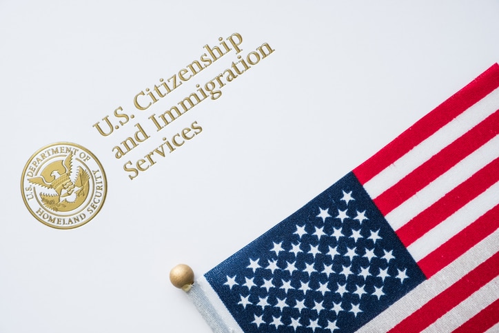 Official U.S. immigration notice and American flag