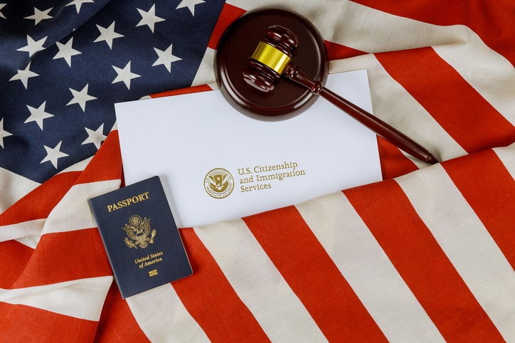 U.S. passports and a judge's gavel representing ICE check-ins and immigration law in New York